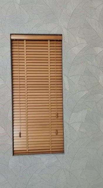 its wallpaper. and wooden blinds. along with matching curtain