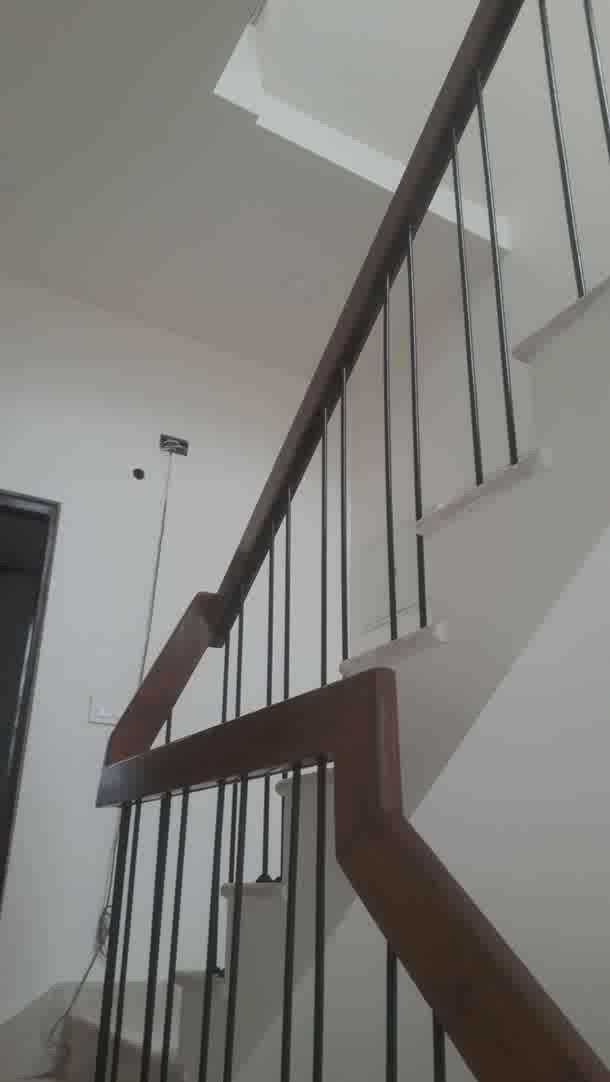 # staircase railing with wooden handrail.