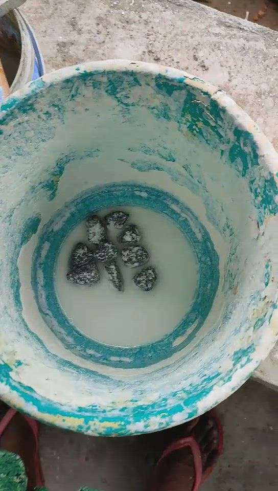 put some stones in white  cement bucket..throughout painting that will help keep it stirred.. and help it..mix well