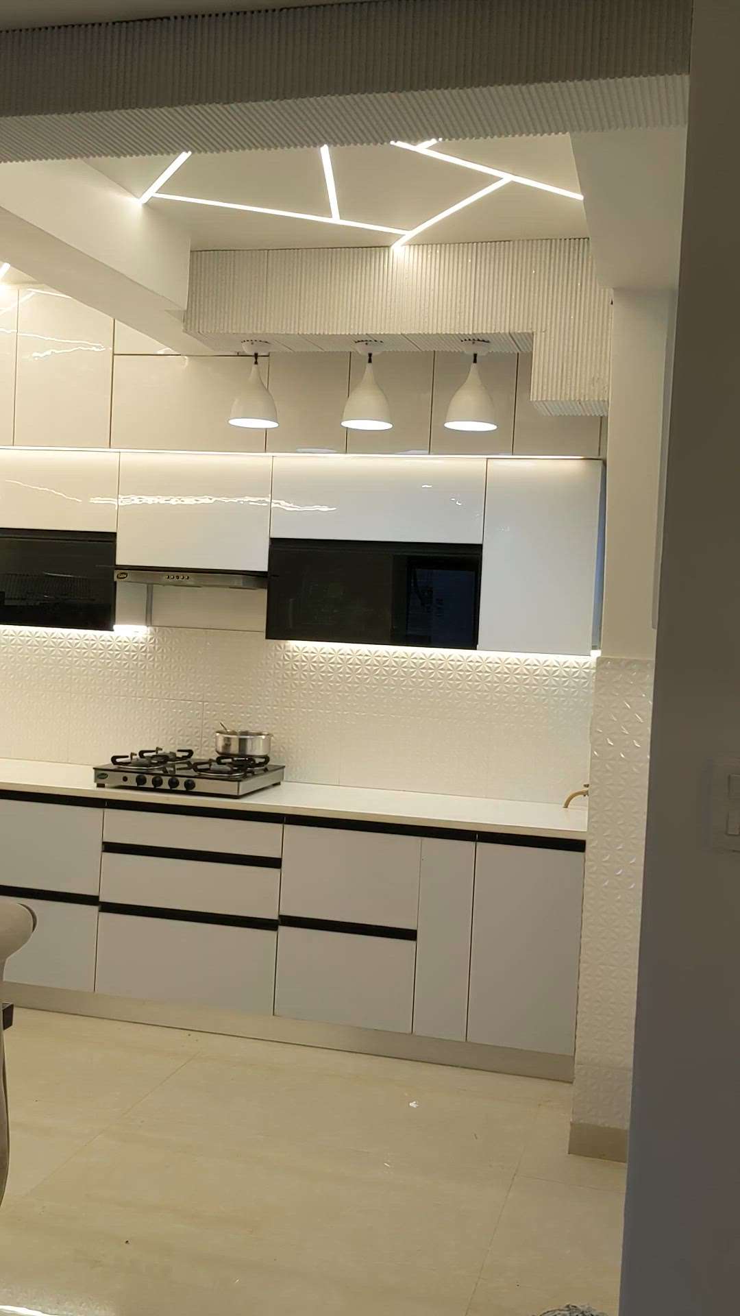 luxury modular kitchen in Acrylic finish with profile light ceiling. # modular kitchen  #buildcraftassociates  #modernkitchenstyle #acrylickitchendesigns  #homeinteriordesign