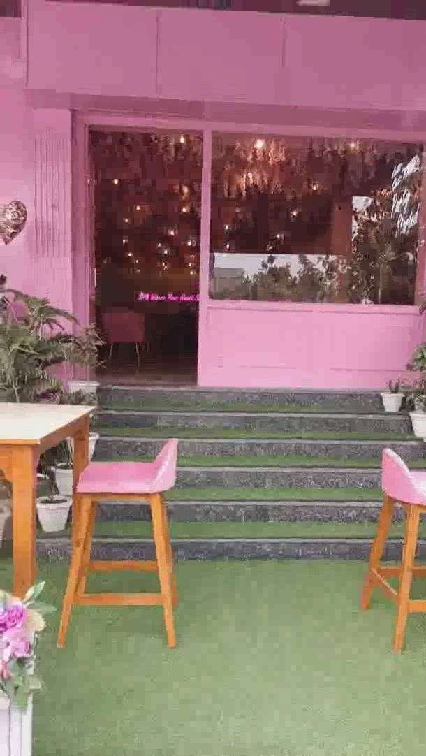 #cafe design with planting roof with pink color combination design looks very attractive .
