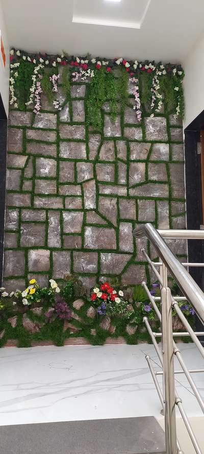 Wall stone texture..with artificial grass with flawers decor...