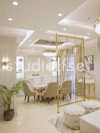 Luxurious interior design for a 2500 sqft apartment for a family in Gurgaon. Light tones with gold accent colour in screens and furniture to give a richness to the whole space. Clean floor plate maximizing the utilisation of space without cluttering. #LUXURY_INTERIOR #stonework #beigeaesthetic #aesthetic #InteriorDesigner #architecturedesigns #Architectural&Interior #GOLDEN #CelingLights #stoneflooring