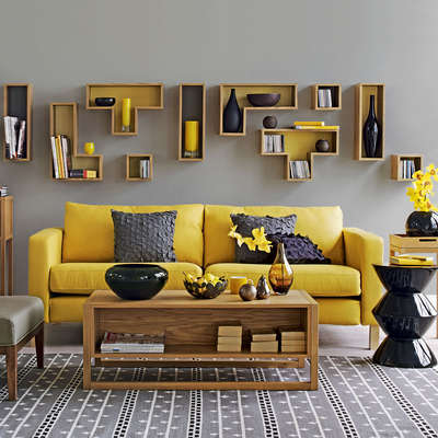 Get this bright and solid, yellow-grey living room with mustard sofa, display of geometric shelving, storage coffee table and dark charcoal accessories.
#interior #decor #ideas #home #interiordesign #indian #colourful #decorshopping