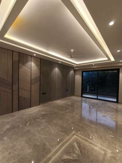 A beautiful combination of flooring and false ceiling with profile lights. #interiordesign #interiors #lights #flooring #flaseceiling #interiors #hall #luxuryinterior #profilelights #lighting #marble #interiorshapes #interiorshapesandesigns