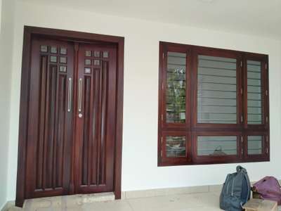 wooden double door
കുന്നിമരം