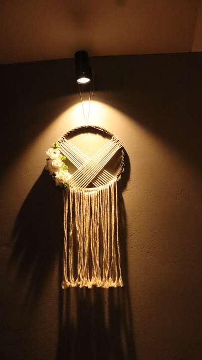 minimal wall enhanced with macrame dreamcatcher hanging and spot light
