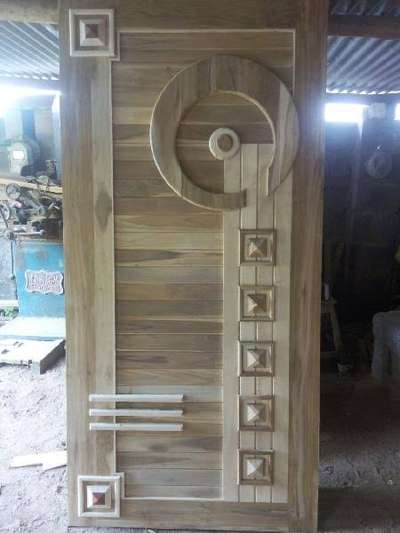 Teakwood door with white colour wood used to decorate the design. Only our carpenter designed this door with his skill. Long life guarantees from our