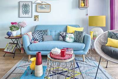Get this living room with blue and yellow accents with : Pastel blue sofa, printed cushions, table lamp with yellow shade, glass coffee table, geometric rug and purple curtains.
#interior #decor #ideas #home #interiordesign #indian #colourful #decorshopping
