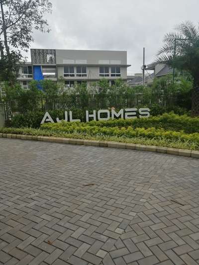 AJL homes villa project Landscape. shrubs arrangements in between Name Tag. more enquiry contact @AG. all Kerala service available.