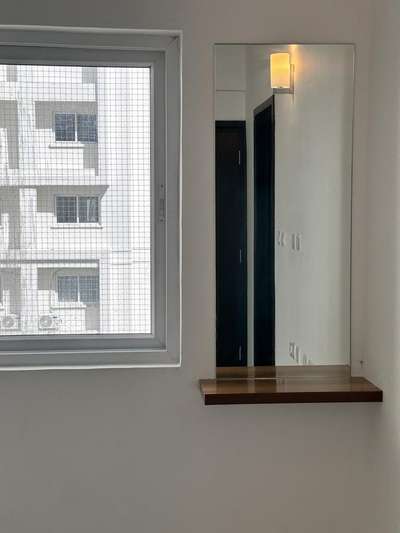 A small dressing area for an apartment available for rent is situated just opposite the entrance door, offering an elongated perspective and an illusion of a larger room.