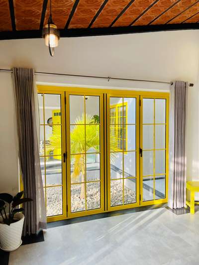 Sliding folding Door  
Yellow shade with Georgian bars 

 #FoldingDoors 
 #AluminiumWindows 
 #aluminium_system 
 #newhome #homedesignkerala #newhouse #keralahomeplanners #homedesign
#sustainabledesign #archkerala
#tropicalarchitecture #architecturedesigns