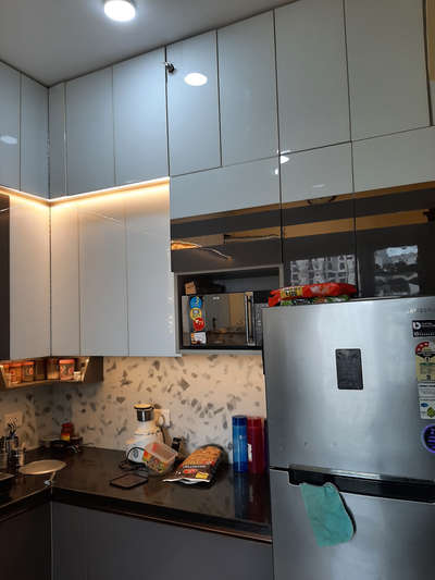 L shape kitchen with Grey and white combination in Acrelic.