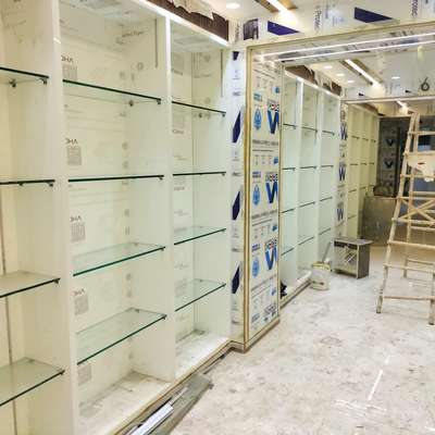 glass racks for garment showroom made by J,S glass and aluminium
