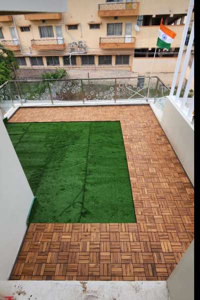 brazilian wooden flooring with artificial grass on terrace.
