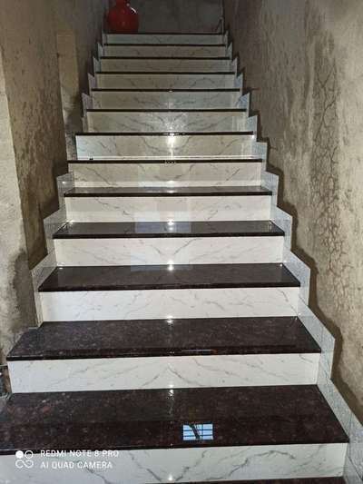 granite staircase with raiser tiles