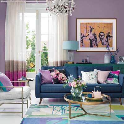 Get this modern living room with contemporary furniture pieces. Purple from the walls, gold from the coffee table, and blue from the couch blend together with the vibrancy of the rug and throw pillows giving the room an eclectic personality.
#interior #decor #ideas #home #interiordesign #indian #colourful #decorshopping