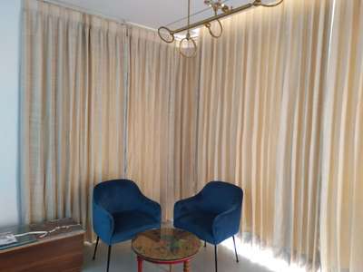 pleated curtains and single chair