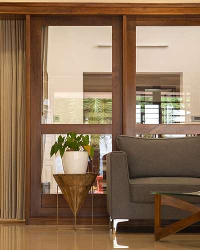 Rajesh Residence #LivingroomDesigns  #KeralaStyleHouse #IndoorPlants #partitions #Teak