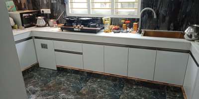 kitchen cabinet with white acp and handle section steel