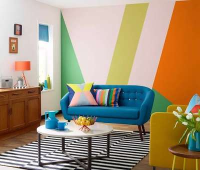 Create this wildly colourful space with products :- tufted blue sofa with multicoloured buttons, multicolour striped cushions, blue roll the curtain, and vases. The black & white striped rug and white coffee table help to balance the look. #interior  #decor  #ideas  #home  #interiordesign   #indian  #colourful #decorshopping