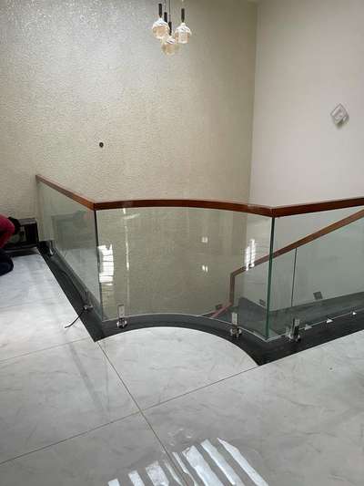 Bend glass and toughened glass handrail. Side mounted. 10 mm toughened glass. Top rubwood-Rubco 2"x 2".
Site in Chingavanam.