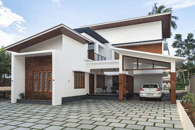 Residence Renovation for Mr. shabeer and Family

The residence for Mr.shabeer was already in a state of shambles as years of harsh weather had caused multiple leaks and mold to form. The elevation  was also in dire need of a refresh. We were approached by the client to solve all issues while staying within his budget. We conceptualized three elements that would change the design of the residence while also solving leakage issues. A canopy was the first design element that was added, this would bring a modern touch to the existing structure while also providing sufficient protection for the walls from natural elements, a ceiling was lined under the canopy to provide both insulation from the heat as well as aesthetics. Laterite cladding was used on the elevation to bring  warmth to the otherwise montonous elevation. Vertical pergolas, angled show walls etc were removed to simplify the overall design. Our intervention has brought back to life a house that was once deemed inhabitable
. 
.