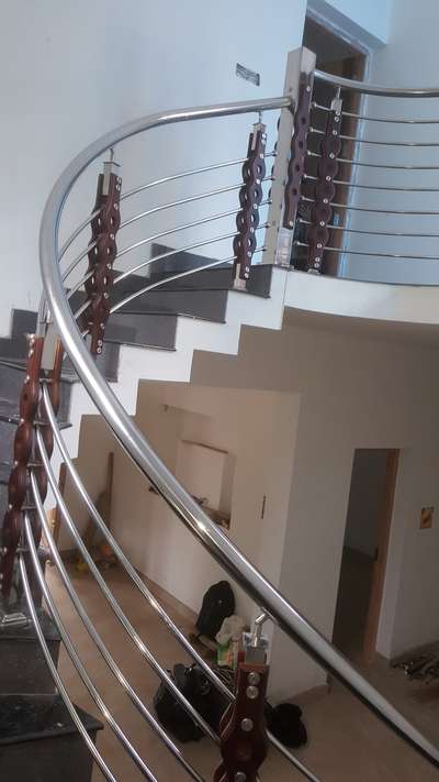curved staircase handrail with wooden leg