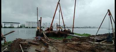 Marine piling with barge at Bolgatty