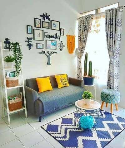 Create your cozy small living room with bright yellow cushions, a 2 seater couch and a comfy ottoman stool. Decorate the walls with a wooden family tree set and a macrame artwork.
#interior #decor #ideas #home #interiordesign #indian #colourful #decorshopping