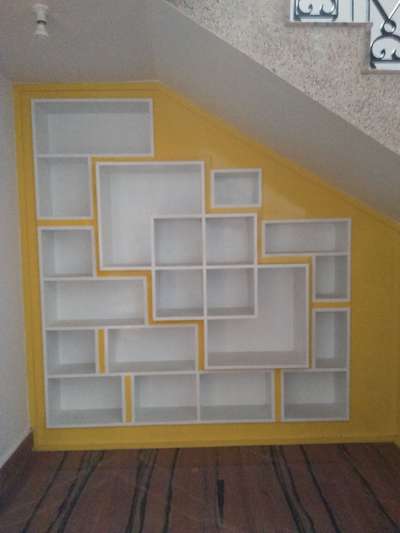 book shelf below the staircase