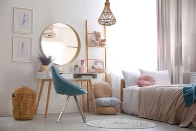 Enjoy a white bedroom with large bed ,round cuddle cushion, wooden shelves, an armchair and a round mirror to create a comforting space.#interior #decor #ideas #home #interiordesign #indian #colourful#decorshopping