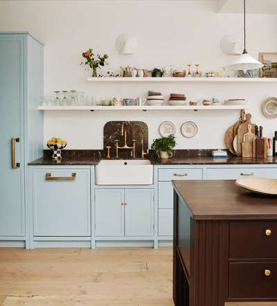 Create this trending pastel blue kitchen with glassware, flower decorations, a white pendant light and wall decor for a peaceful cooking atmosphere.#interior #decor #ideas #home #interiordesign #indian #colourful#decorshopping