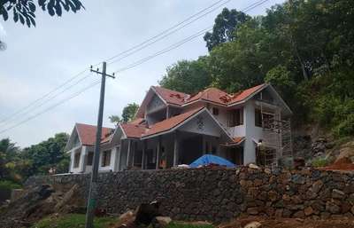 Residence at Naranganam.   Construction Period- Site Photo  #SlopingRoofHouse  #TraditionalHouse   #workinprogress  #facadedesign  #RoofingIdeas  #tileroof  #KeralaStyleHouse  #gableroof  #rubble