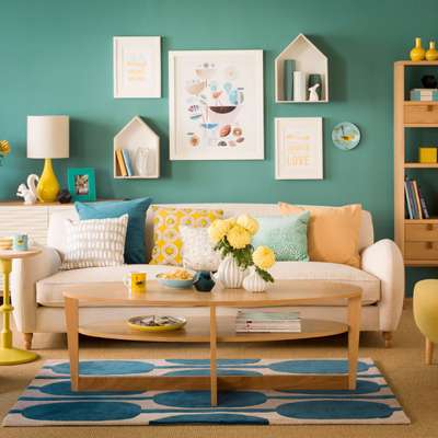 Get this vibrant flair in your living space with the wall painted in green housing shelves and art in white frames. Go for a printed blue and white rug. Add yellow, green and peach cushions on a cream sofa and add plenty of decor in yellow.
#interior #decor #ideas #home #interiordesign #indian #colourful #decorshopping