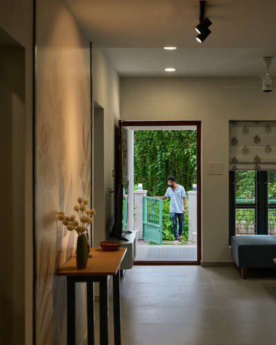A light blue sofa sete the tone for calm living, while a console welcomes you warmly at the entrance - Kilimanoor home's cozy living story.
 #InteriorDesigner  #architecturedesigns  #HouseRenovation