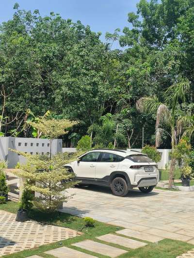 An extra car park space blend with landscape 
completed project 
 #completed_house_construction #LandscapeDesign #carparking #LandscapeGarden #GardeningIdeas #BangaloreStone #grasspavers