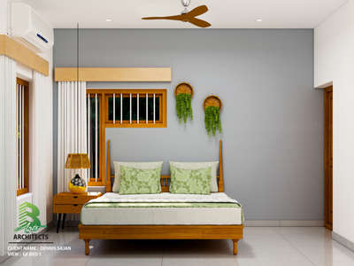 A bedroom with a wooden bed featuring green floral pillows against a gray wall. Hanging green plants in round baskets add a touch of nature. 🏠🛏️🌿

Client : Dennis Sajan
Area : GF Bedroom