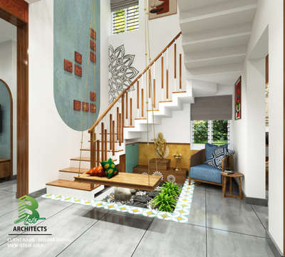 Indoor oasis under a bright white staircase! 🌿✨ 
A wooden swing with vibrant orange & green cushions hangs gracefully over a mini garden bed filled with rocks, white daisy-tiled borders, and lush green plants.

Client : Rehana Manoj
Area : Stair Area