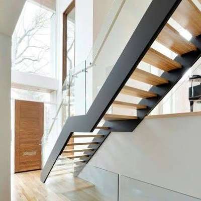 industrial stair case with glass handrail