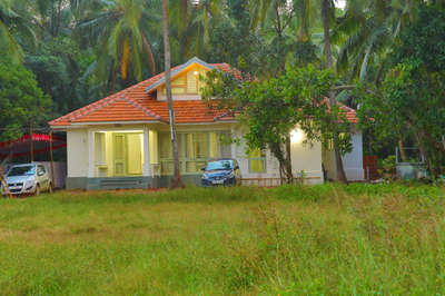 Nestled in a lush tropical setting, this charming 
single story home with a mezzanine floor 
boasts a warm terracotta tiled roof & bright 
white walls. It features large windows that wel-
come natural light & a cozy front porch that 
invites relaxation. The home’s tranquil setting & 
classic design create serene retreat amid the 
vibrant verdant landscape.

 #tantra  #architecturedesigns  #KeralaStyleHouse  #tirur  #Malappuram  #TraditionalHouse  #happyclients