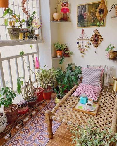 Give major zen vibes to your balcony with different kinds of plants, sculptures, paintings, wind chimes and other decorative hangings. The most noticeable things in this balcony is a traditional Indian charpoy daybed and coconut shell birdhouse. #interior  #decor  #ideas  #home  #interiordesign  #indian  #colourful #decorshopping