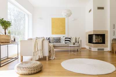 Get this minimalist scandinavian style living room in simple colour pallette with this modern corner sofa with printed B&W cushions, white side table, fluffy white rug, and a modern pendant lamp. Add a touch of natural element with ottomans and basket made of jute. #interior #decor #ideas #home #interiordesign #indian #colourful #decorshopping