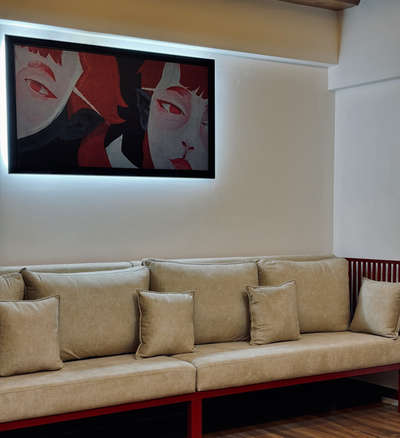 Project type: Interior design and Execution
Location: Pangappara, trivandrum
The Red Thread-
This residential interior project harmoniously blends industrial strength with tropical calm, centered around a unique visual element — red steel bars that subtly connect every custom-built furniture piece. The bold red becomes the common thread weaving through a cohesive narrative of design, linking the sofa, dining table, TV unit, and storage systems into a singular visual language.
Natural textures like walnut wood laminates, botanical graphic wall panels, and ceramic printed dining surfaces contrast beautifully with the industrial robustness of steel, softening the palette with warm beige upholstery and intricate tilework at the wash zone.
Architectural details such as curved wood-clad ceilings, arched niches, and ambient lighting elevate the spatial experience while maintaining minimalism and clarity in function. The space seamlessly balances artistry with utility, presenting a bold, modern yet nature-inspired aesthetic  #KitchenInterior #homeimprovement  #homeinterior  #LivingRoomTable  #LivingroomDesigns #KitchenInterior  #minimalistichome