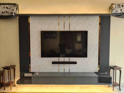 DESIGNER TV UNIT. Used the spare wall in the drawing room to enjoy the theatrical experience of the 60" tv with the guests. 
 #tvunits #InteriorDesigner #HouseRenovation #designers #LivingRoomTV #tvbackpaneling #louverspanel #tvunitinterior  #lights