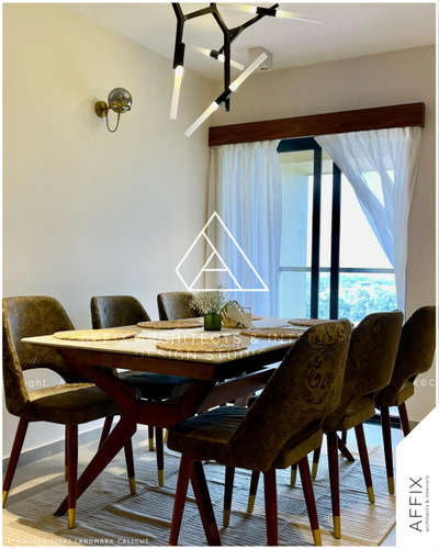 The architectural work of the dining area in the apartment, designed by @ar_shyz_muhammed for  @designersiraj epitomizes a blend of practicality and sophistication. The dining chairs are strategically placed near the sliding door, optimizing natural wind flow and offering a scenic view, thus creating an inviting atmosphere. The chairs are distinctively designed with a special green-colored fabric that not only enhances the visual appeal but also introduces a tactile dimension with its intricate patterns. This thoughtful choice of fabric adds a layer of texture and elegance, enriching the dining experience and complementing the overall aesthetic of the space.
.
.
.
.
.
.
.
.
.
.
.
.
.
.
Project Name: AFA-K-116- SIRAJ LANDMARK CALICUT 
Designed by: @ar_shyz_muhammed
Photography : @ar_shyz_muhammed
Client: @designersiraj
Words : @cq___vp

.
.
.
.
.
.
.
.
.
.
.
.
.
.
#architecture #architecturephotography #exteriordesign #landscape #landscapephotography #archilovers #homedecor #homearchitecture #villa #lakeview #kannurarchitects #moderninterior #interiordesignvadakara #archdailyprofessionals
