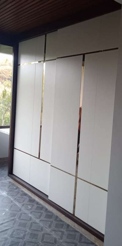 Sliding wardrope with golden profiles.