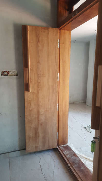 simple teakwood double door with wooden handle