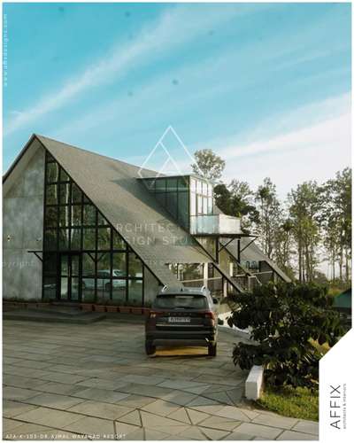 A contemporary resort design featuring bold sloping roofs, expansive glass façades, and clean geometric lines that merge architecture with the surrounding landscape. The extensive use of glass enhances natural light and frames the scenic views, while the sharp roof forms create a striking architectural identity #Architect  #architecturedesigns  #Architectural&Interior  #architectsinkerala  #kerala_architecture  #resort_work  #resort@wayanad