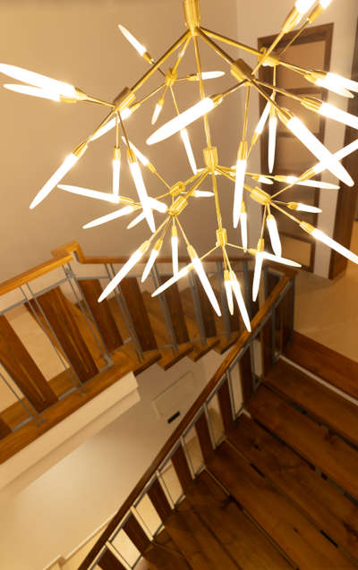 Elevating spaces with elegance and light ✨ Loving how this modern chandelier adds warmth and style to the staircase! #InteriorDesign #HomeDecor #modernliving